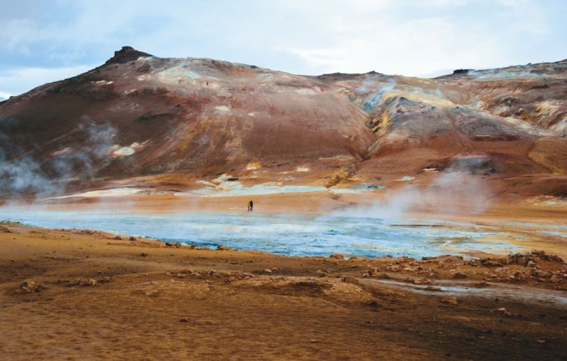 Geothermal System - a man standing in the middle of a body of water