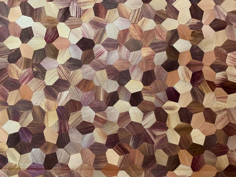 Sustainable Materials - a close up of a rug made of wood