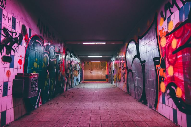 AI Urban Planning - empty tunnel pathway with graffiti walls